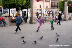 Kids playing with the pigeons in downtown Morelia.