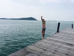 My daughter jumping off the pier at Telunas Beach Resort.