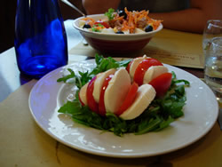You can keep it light, and order a classic Caprese salad (tomato, mozzarella and basil). 