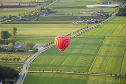 Balloon ride over the green fields of Netherlands