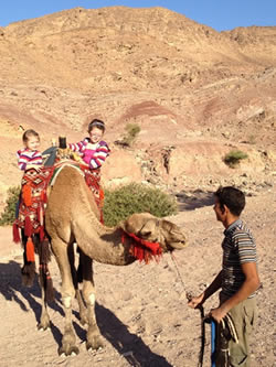 Madeleine & Tilda riding a camel