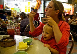 Jennifer and her son eating Yum Cha at the Tai Po wet market.