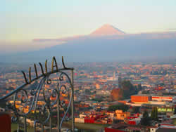 Sunrise view of the PopocatÃ©petl volcano from atop the Cholula pyramid